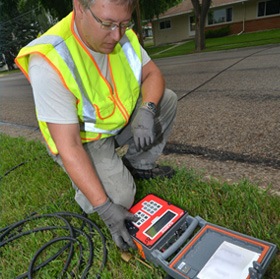 Technician deploying traffic counting meter