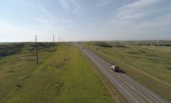 Stretch of two way US 85 roadway - Junction ND 200 North to RP 120.3. Green lush grass with blue sky.